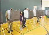  ?? File photo ?? A young girl stands next to a voter during the 2019 local elections.