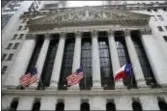  ?? THE ASSOCIATED PRESS ?? The Texas state flag, right, flies outside the New York Stock Exchange, which has committed more than $1 million for Harvey relief efforts. U.S. stocks rose again Thursday as investors were pleased with a report that showed spending by U.S. consumers...