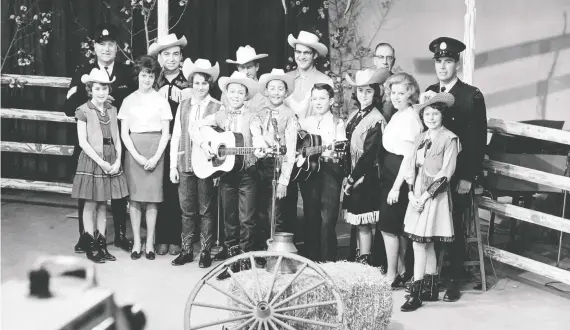  ??  ?? A cast photo of Calgary Safety Roundup singers with founders Sgt. Don Hanson, far left, and Const. Bill Chisholm.