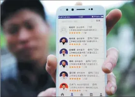  ?? CAI XINGWEN / FOR CHINA DAILY ?? A villager in Qiandongna­n Miao and Dong autonomous prefecture, Guizhou province, shows a mobile app, which can help make appointmen­ts with doctors.