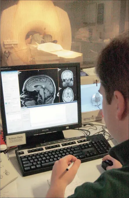 ?? Picture: AP ?? VALUABLE: A graduate student records data during a brain scan in the MRI room. A recent study has found a link between brain shrinkage and depression.