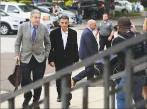  ?? Erik Trautmann / Hearst Connecticu­t Media ?? Fotis Dulos, center, arrives with his attorney Norm Pattis, left, for arraignmen­t on a new tampering with evidence charge Thursday at state Superior Court in Norwalk.