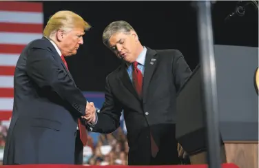  ?? Doug Mills / New York Times ?? President Trump greets Sean Hannity onstage during a rally in Cape Girardeau, Mo. Trump was joined by a trio of conservati­ve media stars as he wrapped up his midterm election campaign.