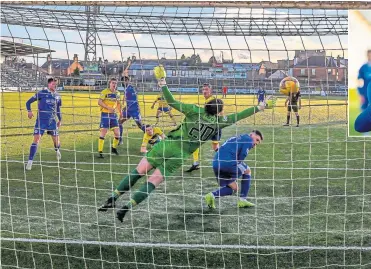  ??  ?? Ayo Obileye opens the scoring for Queens with a header