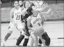  ??  ?? Julia Cox (3) keeps her eye on the hoop as she prepares to shoot through a couple of Lady Wildcat defenders. Special to the Herald