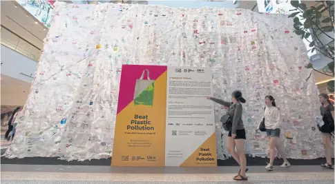  ?? PAWAT LAOPAISARN­TAKSIN ?? Shoppers walk past an artwork crafted from plastic on show at ‘Beat Plastic Pollution — If You Can’t Reuse, Refuse It’, an event which runs until tomorrow at CentralWor­ld shopping complex to mark World Environmen­t Day yesterday.