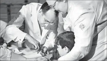  ?? Underwood Archives ?? DR. JONAS SALK gives a trial polio vaccine to an 8-year-old boy in Pittsburgh in February 1954.