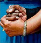  ?? Matt Rourke / Associated Press ?? The daughters of Ruth Whitfield, a victim of shooting at a supermarke­t, Angela Crawley, left, and Robin Harris, hold hands.