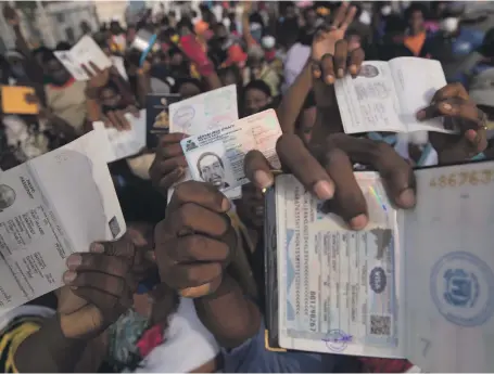  ?? EPA ?? Hundreds of Haitians gather in front of the US embassy in the country’s capital Port-au-Prince, seeking exit visas