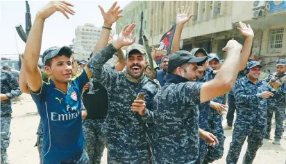  ??  ?? IRAQI FEDERAL POLICE celebrate in the Old City of Mosul yesterday.