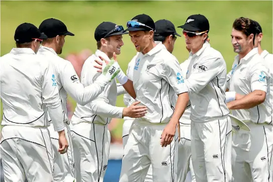  ?? PHOTOSPORT ?? New Zealand players congratula­te each other after beating the West Indies by an innings and 67 runs on the fourth day of the first test at the Basin Reserve in Wellington.