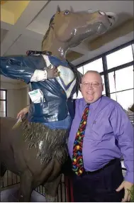  ?? FILE PHOTO BY MATT TURRI ?? Superhorse gets a hug from longtime sports writer and editor Stan Hudy in this 2009 photo in the lobby of what was The Saratogian for more than 100 years and is now Walt and Whitman Brewing. Hudy moved with the newspaper to smaller offices, while Superhorse was put out to pasture.
