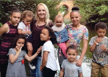  ??  ?? ‘I’VE SAVED UP’: Marie Buchan with her family of eight children. She is having surgery to go from a 34B to a 36DD