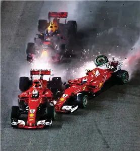  ??  ?? Sebastian Vettel’s Ferrari SF70-H, Max Verstappen’s Red Bull Racing RB13 and Kimi Raikkonen’s Ferrari SF70-H crash at the start of the race at the Singapore Grand Prix.
