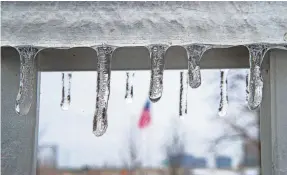  ?? MICHAEL CLEVENGER/USA TODAY NETWORK ?? Ice forms on the handrail of the ramp to the Big Four pedestrian bridge in Louisville, Ky., in 2021. The Muhammad Ali Internatio­nal Airport was briefly closed Tuesday because of the weather.