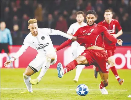  ?? Agence France-presse ?? Paris Saint-germain’s Neymar on Wednesday. (left) vies for the ball with Liverpool’s Joe Gomez during their Champions League match at the Parc des Princes Stadium in Paris