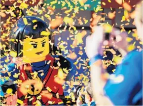  ?? JACOB LANGSTON/STAFF PHOTOGRAPH­ER ?? Confetti falls during the grand-opening festivitie­s Thursday at the new martial arts and ninjatheme­d Ninjago area and interactiv­e ride at the Legoland Florida resort.