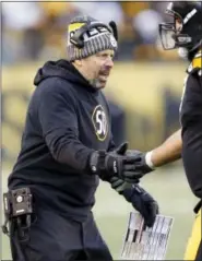  ?? THE ASSOCIATED PRESS ?? Former Pittsburgh Steelers offensive coordinato­r Todd Haley greets players as they come from the field during the second half of Sunday’s NFL divisional football AFC playoff game against the Jacksonvil­le Jaguars in Pittsburgh.