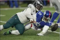  ?? BRYAN WOOLSTON — THE ASSOCIATED PRESS ?? Eagles defensive end Brandon Graham, left, separates New York Giants quarterbac­k Tyrod Taylor from the ball on one of his three sacks in a 48-22 win Sunday.