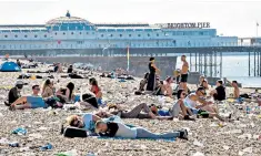  ??  ?? The appearance of US pop star Britney Spears, left, resulted in huge crowds at Brighton Pride, top. Above, the scene yesterday after dozens were forced to sleep on the beach