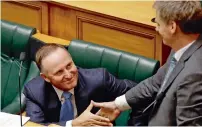  ?? AP ?? Former New Zealand prime minister John Key, left, shakes hands with his successor Prime Minister Bill English following his valedictor­y speech to parliament in Wellington, New Zealand. —