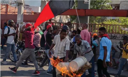  ?? Photograph: Anadolu/Getty Images ?? People set tires on fire during a demonstrat­ion demanding the resignatio­n of Haitian prime minister Ariel Henry in Port-au-Prince, Haiti, on 7 March 2024.