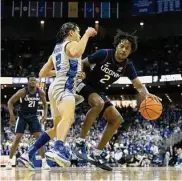  ?? Rebecca S. Gratz/Associated Press ?? UConn’s Tristen Newton, right, drives against Creighton’s Ryan Nembhard during the first half Saturday in Omaha, Neb.