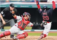  ?? (Reuters) ?? CLEVELAND INDIANS baserunner Rajai Davis (right) beats the tag from Cincinnati Reds catcher Ramon Cabrera to score a fourth-inning run in the Indians’ 15-6 home rout of the Reds on Monday night.
