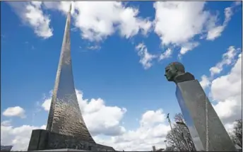  ?? (AP/Alexander Zemlianich­enko) ?? The bust of Gagarin and the 351-feet high titanium obelisk depicting a starting rocket is dedicated to the first cosmonauts in Moscow.