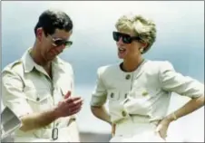  ??  ?? In this April 23, 1991, photo, Britain’s Prince Charles and Princess Diana laugh together during their visit to an iron ore mine near Carajas, Brazil.