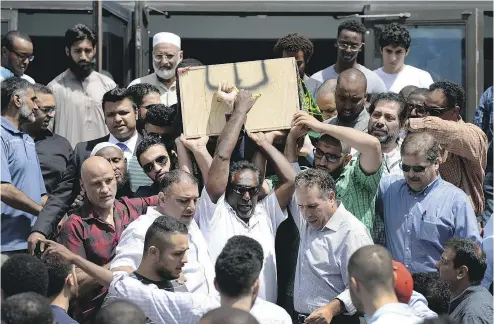  ?? JUSTIN TANG / THE CANADIAN PRESS ?? The casket of Abdirahman Abdi is carried out of the Ottawa Mosque after his funeral on Friday.