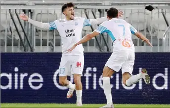  ?? — AFP photo ?? Marseille’s Cengiz rnder (left) celebrates after scoring against Bordeaux.