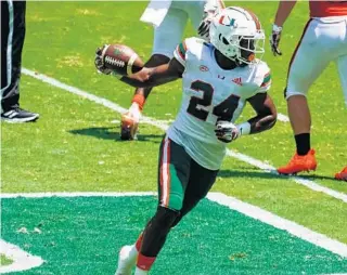  ?? TIM BROGDON/MIAMI ATHLETICS ?? Hurricanes freshman safety Kamren Kinchens after intercepti­ng a pass in UM’s spring game on Saturday at Hard Rock Stadium.