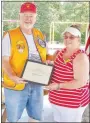  ?? Submitted Photo/KAREN BENSON ?? Al Blair, outgoing president of the Gravette Lions Club, presents Snooky Garrett a certificat­e and pin honoring her as the club’s 2019-2020 Lion of the Year.