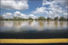  ?? Gina Ferazzi Los Angeles Times ?? ALMOND ORCHARDS are awash in murky water outside the community of Pixley, north of Earlimart, Calif., in Tulare County.