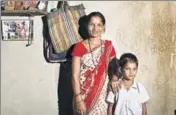  ?? KUNAL PATIL/HT ARCHIVE ?? Ranjana Sonawane stands near a photo of her getting an Aadhaar number, in Maharashtr­a’s Tembhli village.