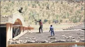  ?? Picture: MASI LOSI ?? MAJOR TASK: Workers fix a roof in Pinehaven country estate in Johannesbu­rg that was damaged during the stormy weather