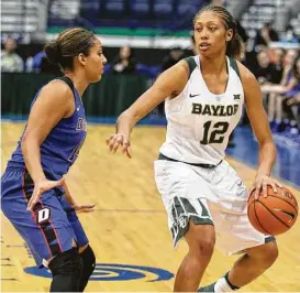  ?? Luis M. Alvarez / Associated Press ?? Baylor’s Alexis Prince (12) moves the ball against DePaul’s Jessica January in the first half Saturday. Prince scored 19 points in the Lady Bears’ 104-72 victory.