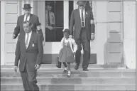  ?? Associated Press file photo ?? U.S. deputy marshals escort 6-year-old Ruby Bridges from William Frantz Elementary School in New Orleans, in November 1960.