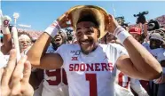  ?? AP Photo ?? ■ Oklahoma quarterbac­k Jalen Hurts (1) puts on the Golden Hat after the Sooners beat Texas, 34-27, at the Cotton Bowl on Saturday in Dallas.