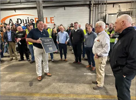  ?? JEN SAMUEL - FOR MEDIANEWS GROUP ?? John Luciani, left, chief operating officer of LTL Solutions at A. Duie Pyle, presents a bronze plaque from the “Pyle People” to Peter Latta alongside his brother, Jim Latta. The plaque is dedicated to the Pyle family to mark the company’s centennial in Chester County.