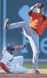  ?? StaFF PHoto by nancy Lane ?? LOOK OUT BELOW: Jackie Bradley Jr. is forced out at second base on a double play turned by Yuli Gurriel during the fourth inning of the Red Sox’ 4-3 loss to the Astros yesterday.