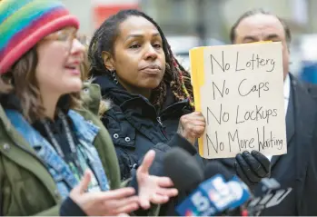  ?? BRIAN CASSELLA/CHICAGO TRIBUNE ?? Vitoria Herring holds a sign on March 29 during a rally outside the Thompson Center by the group True Social Equity in Cannabis.