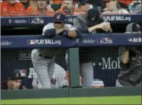  ?? DAVID J. PHILLIP — ASSOCIATED PRESS ?? Players watch from the dugout during the ninth inning of their 7-2 loss in Game 1 of the American League Division Series against the Astros in Houston.