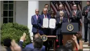  ?? AP PHOTO/EVAN VUCCI, FILE ?? In this June 5 file photo, President Donald Trump poses for a photo after signing the Paycheck Protection Program Flexibilit­y Act during a news conference in the Rose Garden of the White House in Washington.