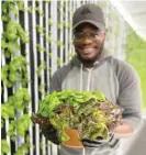  ?? PROVIDED ?? Derek Drake works on his hydroponic farm in a converted shipping container in Mokena.