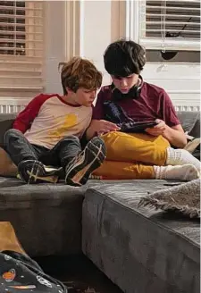  ?? Contribute­d photo/Claire Tisne Haft ?? Claire Tisne Haft's sons, Louie and George, addicted to their devices.