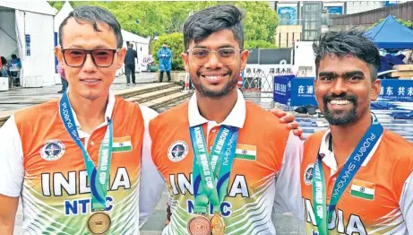  ?? ?? Indian recurve men's team of Tarundeep Rai, Dhiraj Bommadevar­a and Pravin Jadhav after winning.