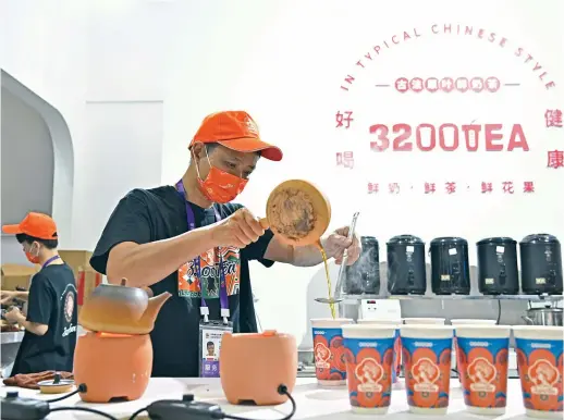  ?? ?? Exhibitors make milk tea for visitors at the 3rd China Internatio­nal Consumer Products Expo in Haikou, south China’s Hainan Province, on April 12. Chinese new-style tea drinks have become a cup of tea for many young Chinese consumers. — Xinhua