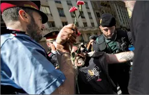  ?? AP/EMILIO MORENATTI ?? Spanish police in Barcelona arrest a protester who was attempting to block a police vehicle transporti­ng Catalonia government official Xavier Puig, who was arrested Wednesday as part of a crackdown by national authoritie­s on Catalonia’s plan to hold a...